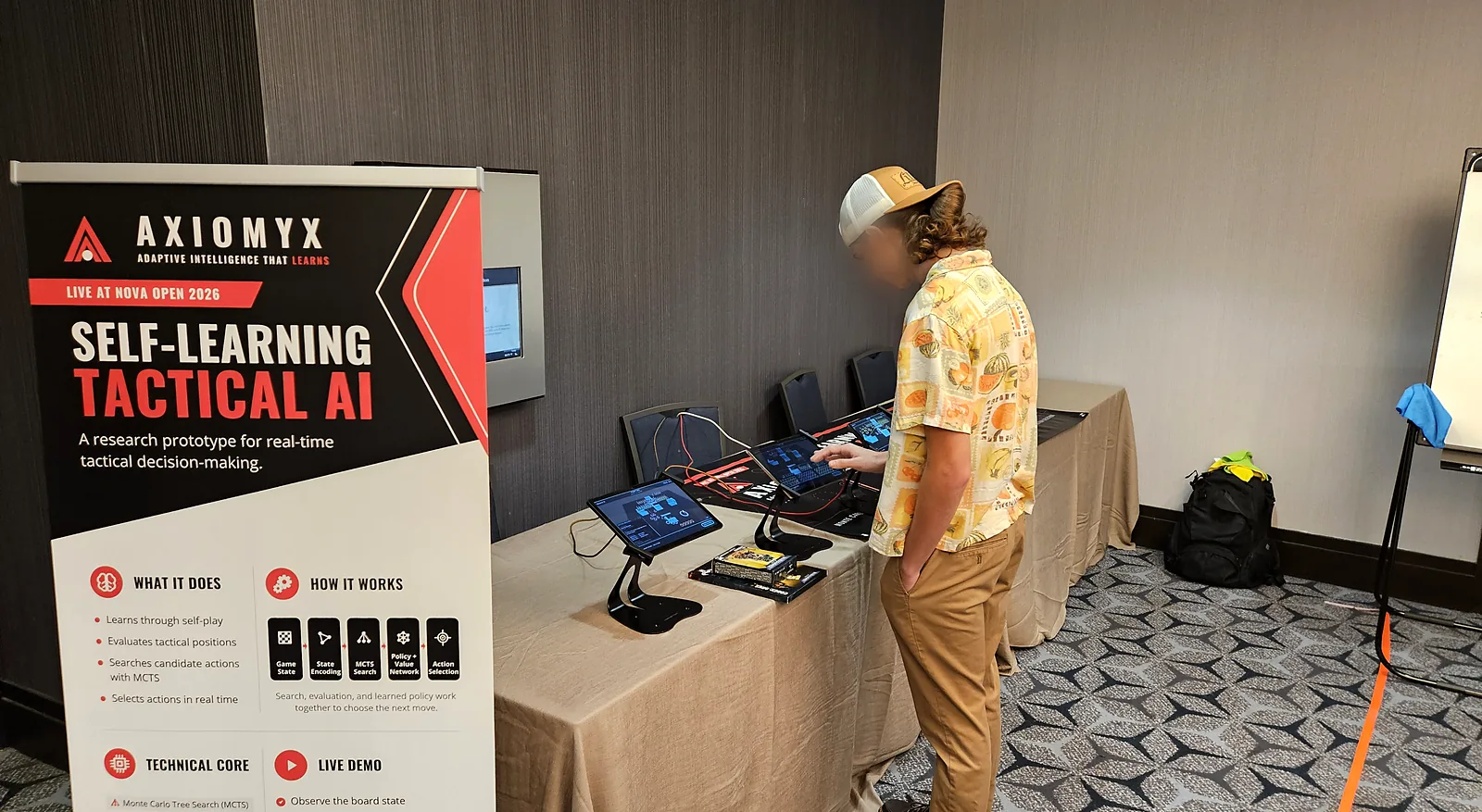 A player working through a match against Axiomyx on a booth tablet at Nova Open 2026.