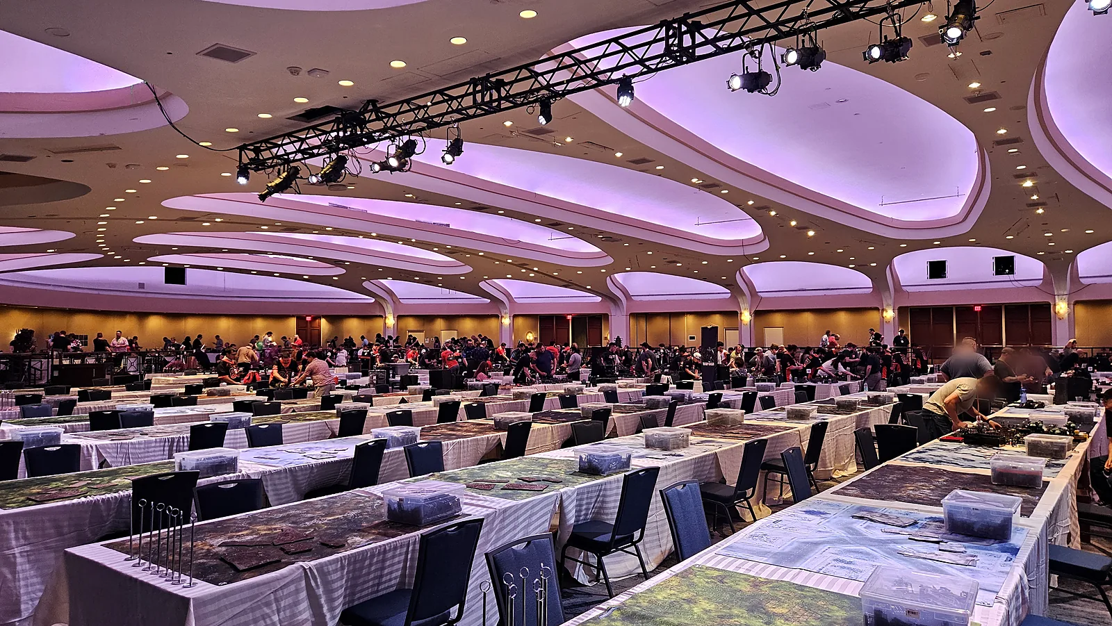 The main Nova Open 2026 tournament hall, with long rows of terrain-covered gaming tables.
